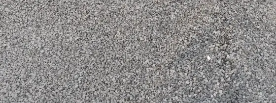 Pile of grey angular Black Star Gravel at the Casco Organics yard, small even stones across the whole frame