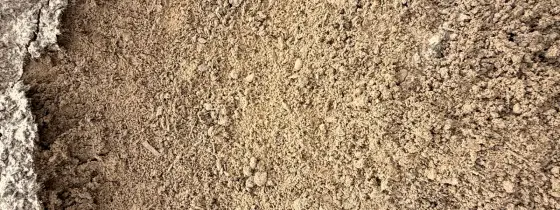 Close-up of light tan, sandy Lawn Mix with small crumbs of compost